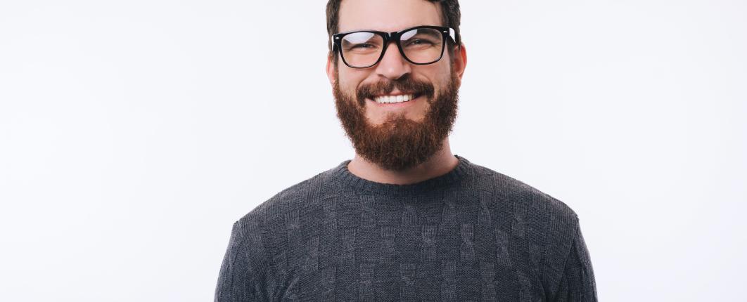homme souriant barbu avec des lunettes de vue