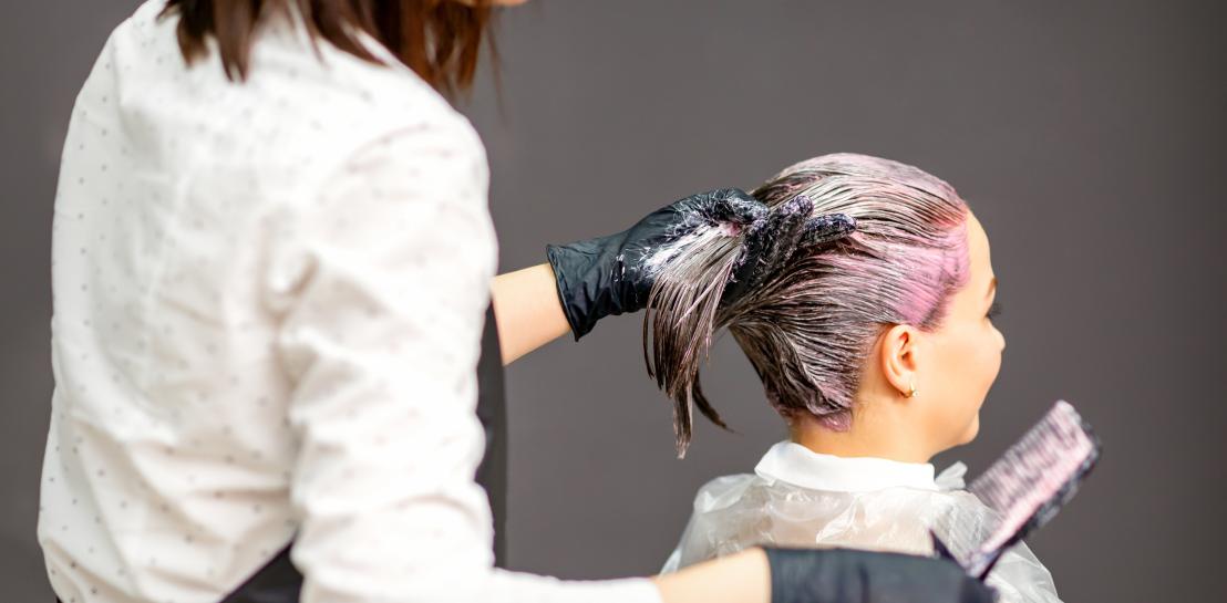 Coiffeuse en train d'appliquer une couleur à une cliente 