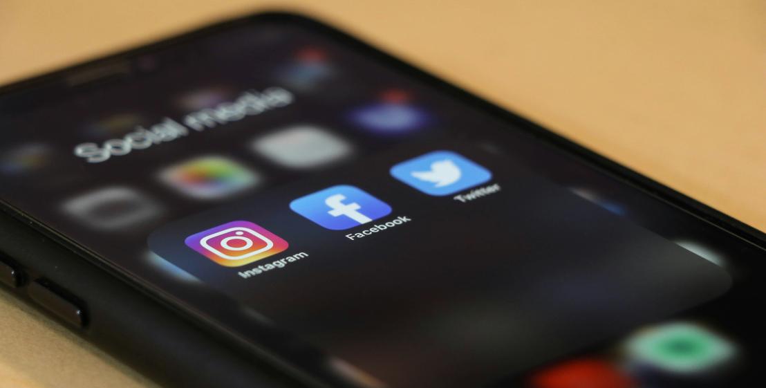 Smartphone sur son écran d'accueil affichant des applications de réseaux sociaux