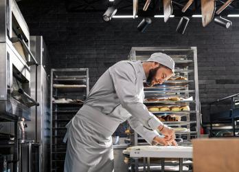Homme boulanger qui prépare du pain dans son atelier