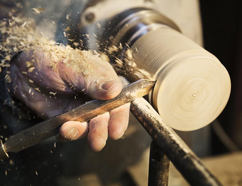 Photo de travail d'un tourneur sur bois en gros plan